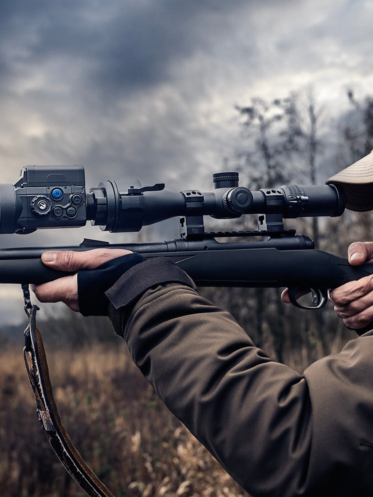 Pulsar Krypton 2 clip-on mounted in front of a day scope, hunter aiming in the field