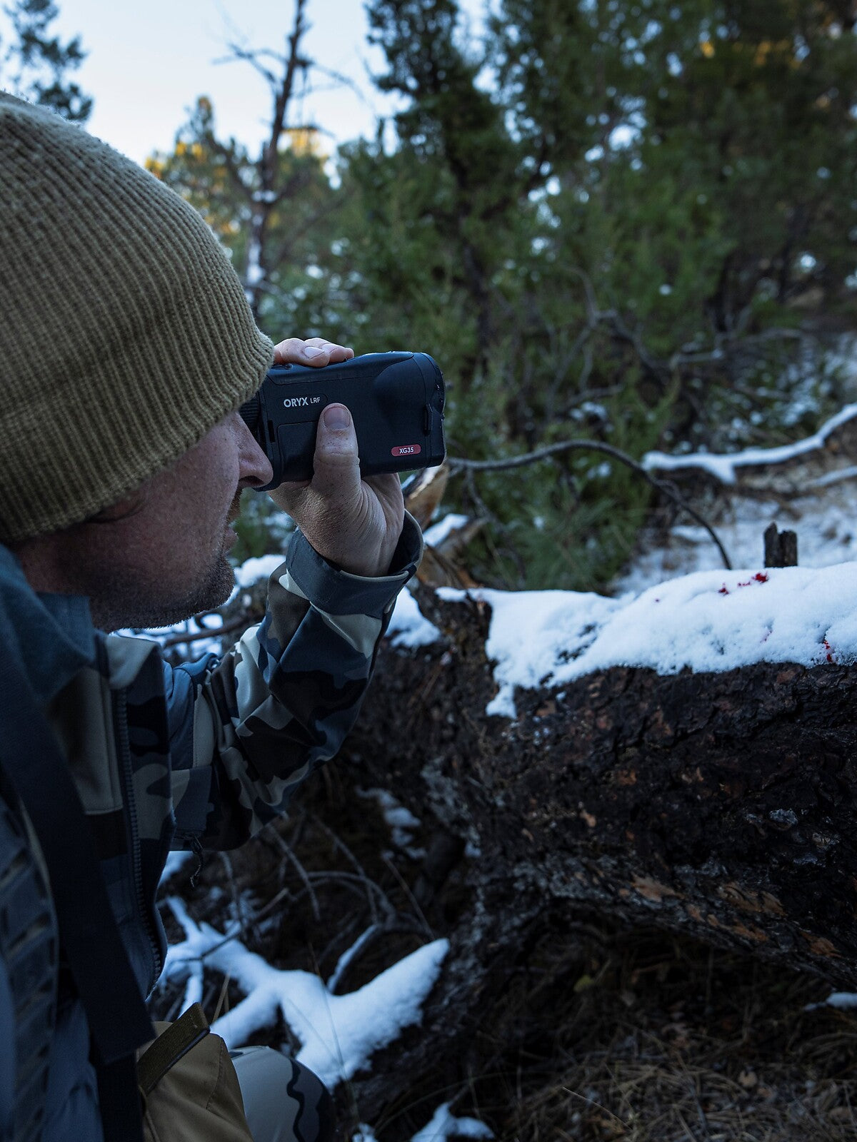 Pulsar Oryx LRF XG35 in use, hunter glassing from cover in the snow