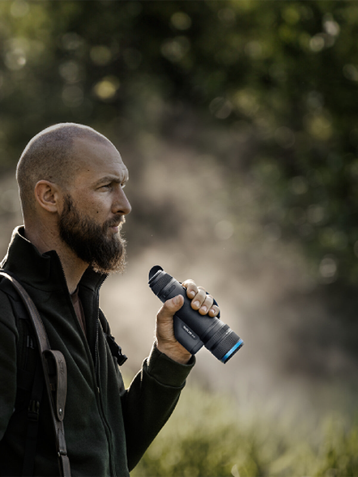 Pulsar Telos LRF XL50 in hand, hunter walking in the field
