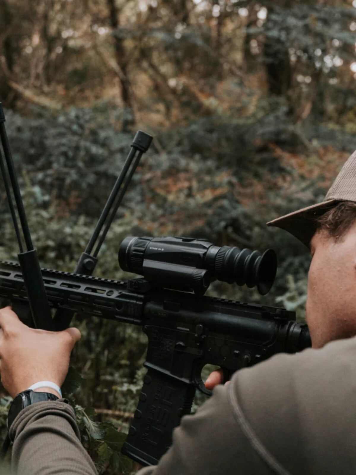 RIX Storm S2R on a rifle, hunter aiming in the woods